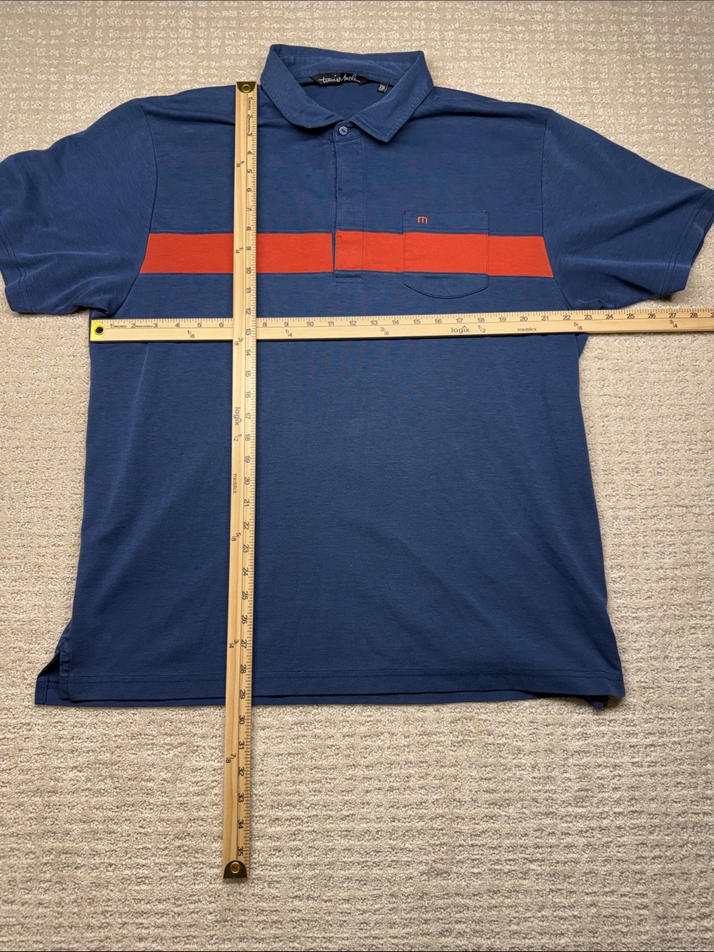 Travis Mathew Blue Polo with Red Chest Stripe